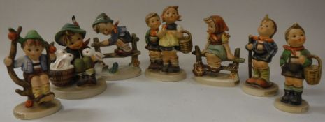 A collection of seven small Goebel Hummel figures of children including "To market" "Retreat to