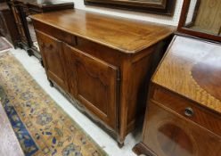 A 19th Century French walnut buffet with single small drawer over two cupboard doors