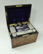 A Victorian coromandel and ebonised vanity case containing various cut glass dressing table bottles
