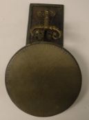 A brass wall hanging gong with dragon decorated mount