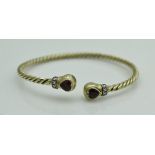 An unmarked 18 carat gold bangle of twisted form,