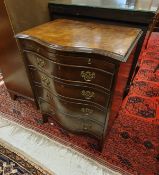 A 20th Century walnut veneered serpentine-fronted bachelor chest of brushing slide over four