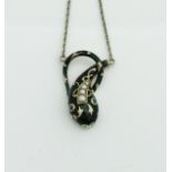 A 9 carat gold enamel and pearl set pendant in the form of a stylised lizard,