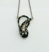 A 9 carat gold enamel and pearl set pendant in the form of a stylised lizard,