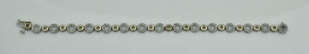 A 9 carat yellow and white gold bracelet of hoop design, the white metal hoops set with diamonds,