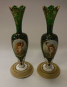 A pair of 19th Century Bohemian green glass vases with white enamel plaques decorated with floral