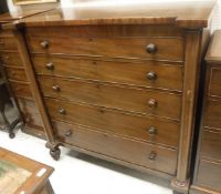 A 19th Century mahogany scotch type chest of five long graduated drawers flanked by turned side