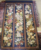 A Belgium style needlework/tapestry wall hanging of three bands of fruit and flowers on blue ground