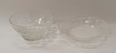 A set of cut glass bowls with engraved grape and vine decoration and matching saucers in the