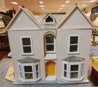 A 20th Century painted wooden doll's house