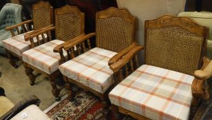 A set of four cane back elbow chairs in the 19th Century style