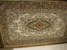 A large tapestry panel with central lozenge shaped medallion in puce, mustard, emerald,