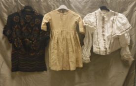 A collection of Victorain and later costume to include a child's cream dress and matching cape