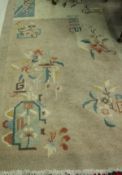 An Art Deco style Chinese rug, the central panel set with floral sprays on pink and cream ground,