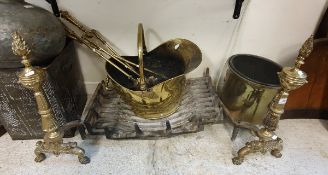 A set of three engraved brass fire irons, brass coal helmet, pair of brass fire dogs,