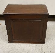 A 19th Century mahogany miniature cupboard with fielded panel door enclosing a bank of eight