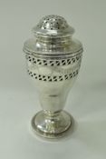 An Edwardian silver sugar caster of pedestal goblet form with pierced and engraved decoration and