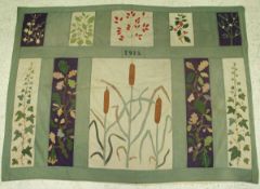 An early 20th Century embroidered panel in the Arts and Crafts manner the central panel depicting