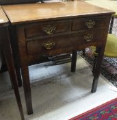 An 18th Century walnut lowboy with two short over one long drawer on square chamfered supports