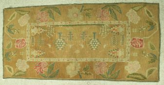 A Victoain needlework panel set with floral sprays,