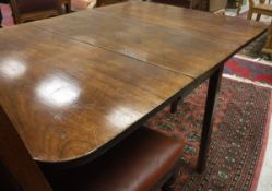 A 19th Century mahogany drop leaf dining table on square chamfered supports