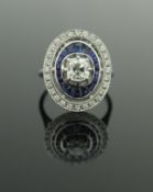 An 18 carat white gold, diamond and sapphire ring,