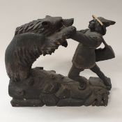 A black forest type carved treen ware figure group of man fighting bear