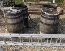 A collection of four cooppered barrels, a cast iron garden water pump,