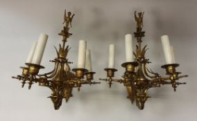 A pair of circa 1900 gilt brass Gothic Revival style wall sconces of four branches with gryphon