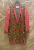 A Hippy Happy coat, the pink and green ground with mirrors decoration in the folk style,