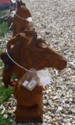 A cast metal ornament of a horse's head on ball and stand