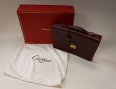 A Cartier burgundy coloured leather briefcase No'd 009648 with two keys,