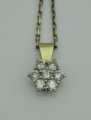 An 18 carat white and yellow gold mounted diamond set pendant in the form of a flower head,