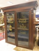 A Victorian mahogany bookcase cabinet the two glazed doors gilt decorated with advertising "Clark's