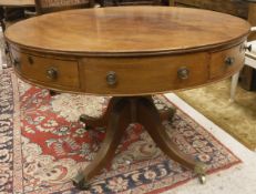 A mahogany drum table in the George III taste,