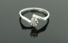 A 9 carat white gold illusion set diamond ring with stylised lined shoulders, size N,