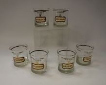 A set of six Cera drinking glasses, each inscribed "Name your poison", including Arsenic,