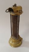 A mid 19th Century un-named Newcastle type miner's lamp with brass mounts and three iron rods