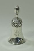 A silver table bell with scrolling acanthus band decoration and bearing monogram "A.S.