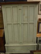 A modern pale green painted two door wardrobe with drawer,