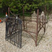 A Victorian wrought iron hay manger and a pair of small black painted heavy wrought iron gates