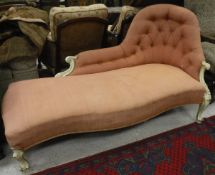 A late Victorian buttoned upholstered chaise longue with painted carved show frame