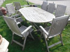 A set of eight Neptune teak folding garden chairs and a similar extending table CONDITION