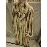 A cream and brown full length fur coat with sateen lining initialled BGH also KCH,