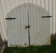 A pair of painted wooden dome topped gates with wrought iron fittings