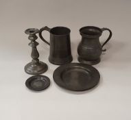 A collection of 18th and 19th Century pewter wares to include two quart measures, four candlesticks,