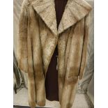 A white otter fur coat, full-length,