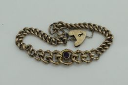 A Victorian 9 carat gold graduated kerb link bracelet set with central amethyst and a heart shaped