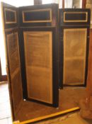 A Victorian ebonised four fold screen with two further four fold screens and a over mantle mirror