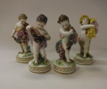 A set of four 19th Century Derby type putti figures as The Four Seasons (one bearing gold anchor
